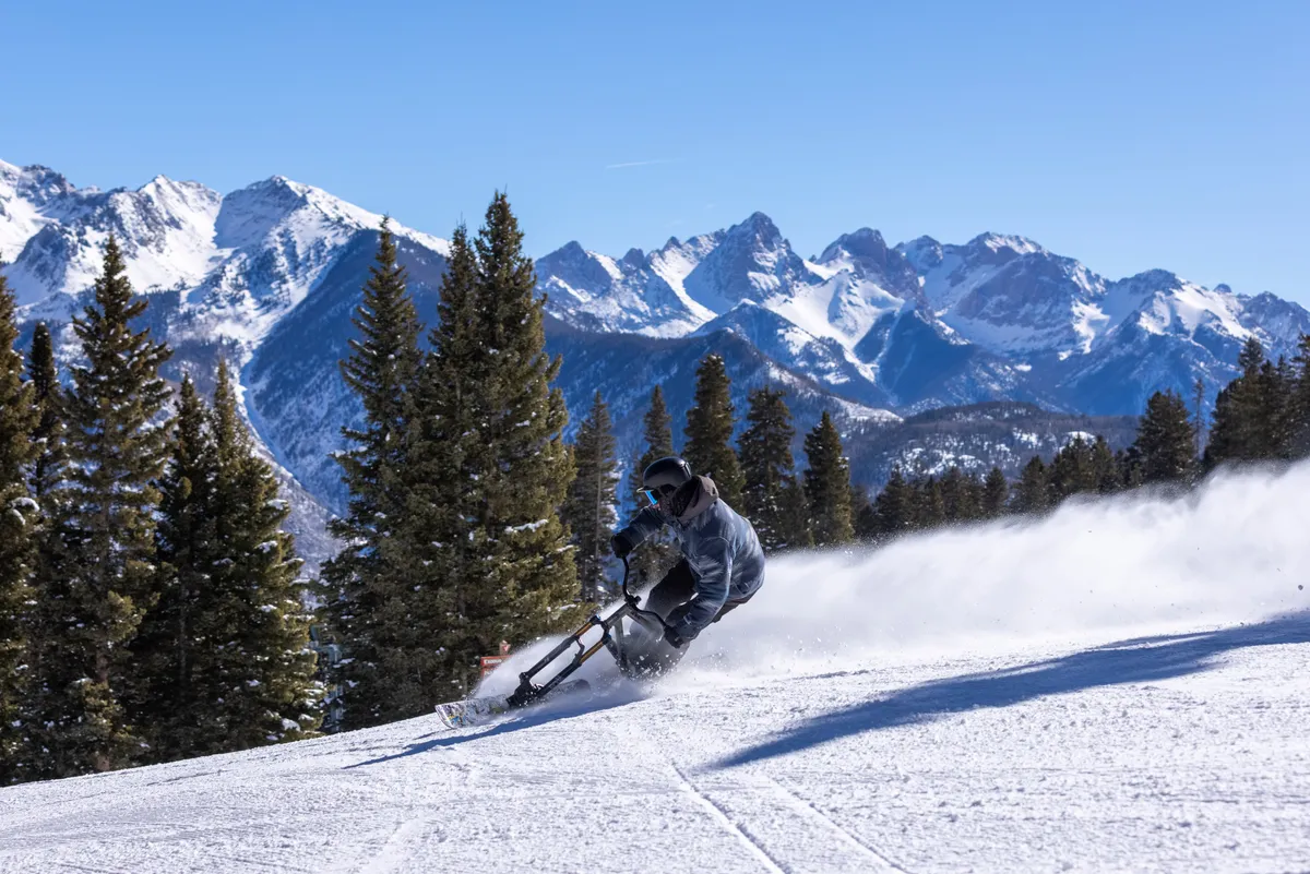 A dynamic winter landscape with a skier gliding down a snowy slope, surrounded by evergreen trees and dramatic mountain vistas. The scene exudes a sense of excitement, discovery, and togetherness amidst breathtaking natural beauty.